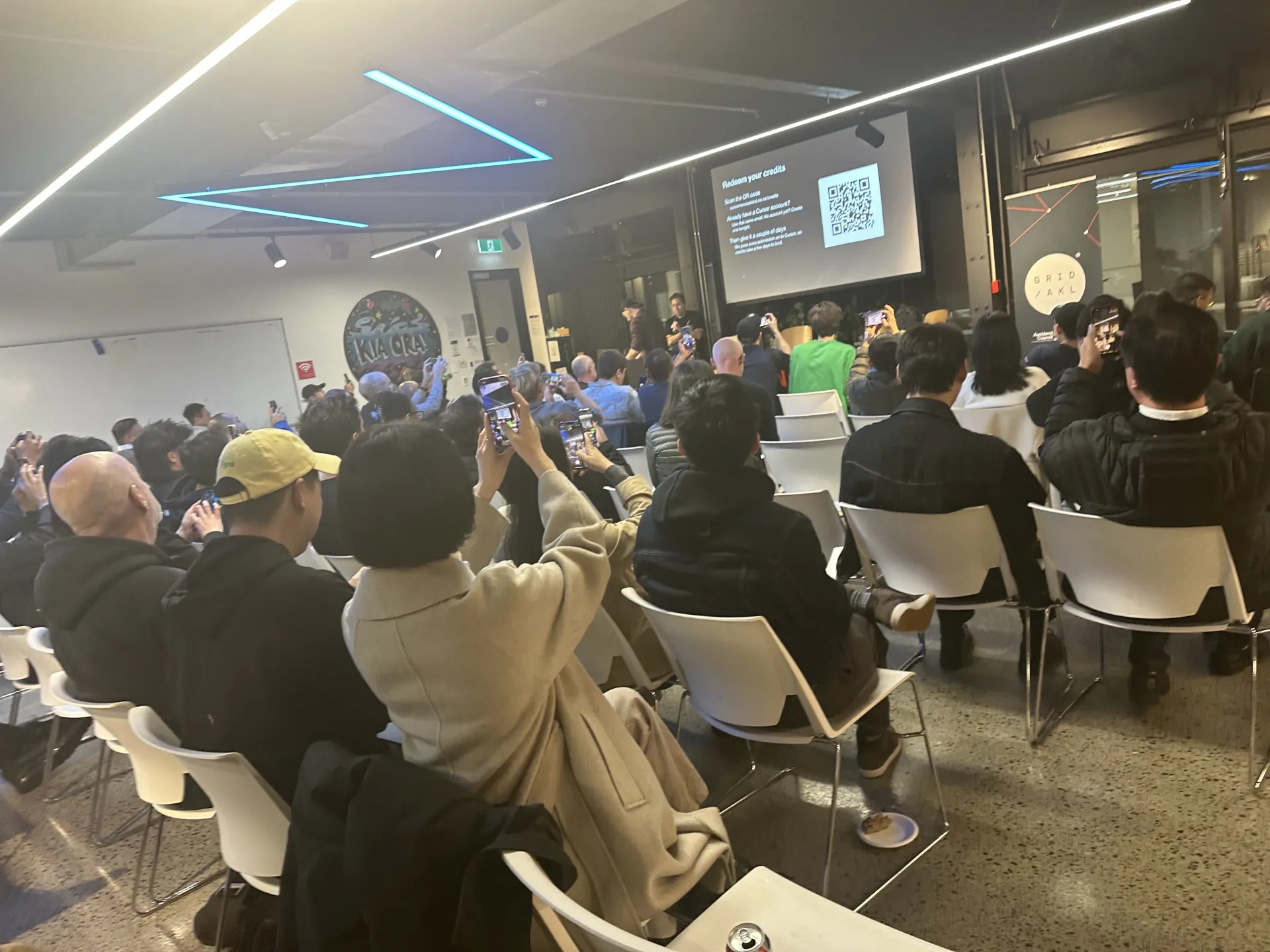 Crowd scanning the QR code to redeem Cursor credits